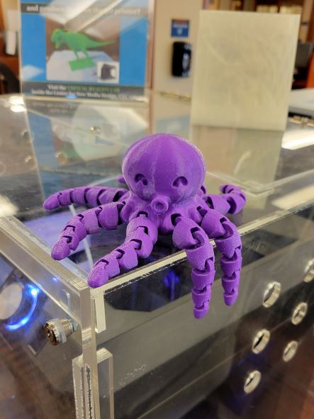 3D printed purple Octopus sitting on one of the Kalamazoo College 3D printers.