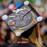 Graduation cap that reads, "so the adventure begins."